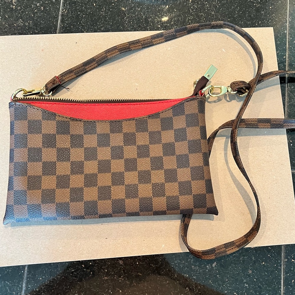 Brown checkered satchel with red accent